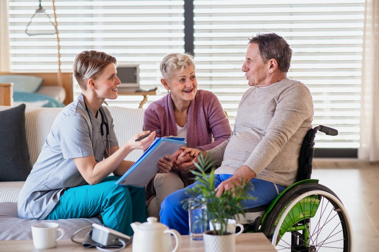 a-healthcare-worker-visiting-senior-patient-in-wheelchair-at-home-.jpg